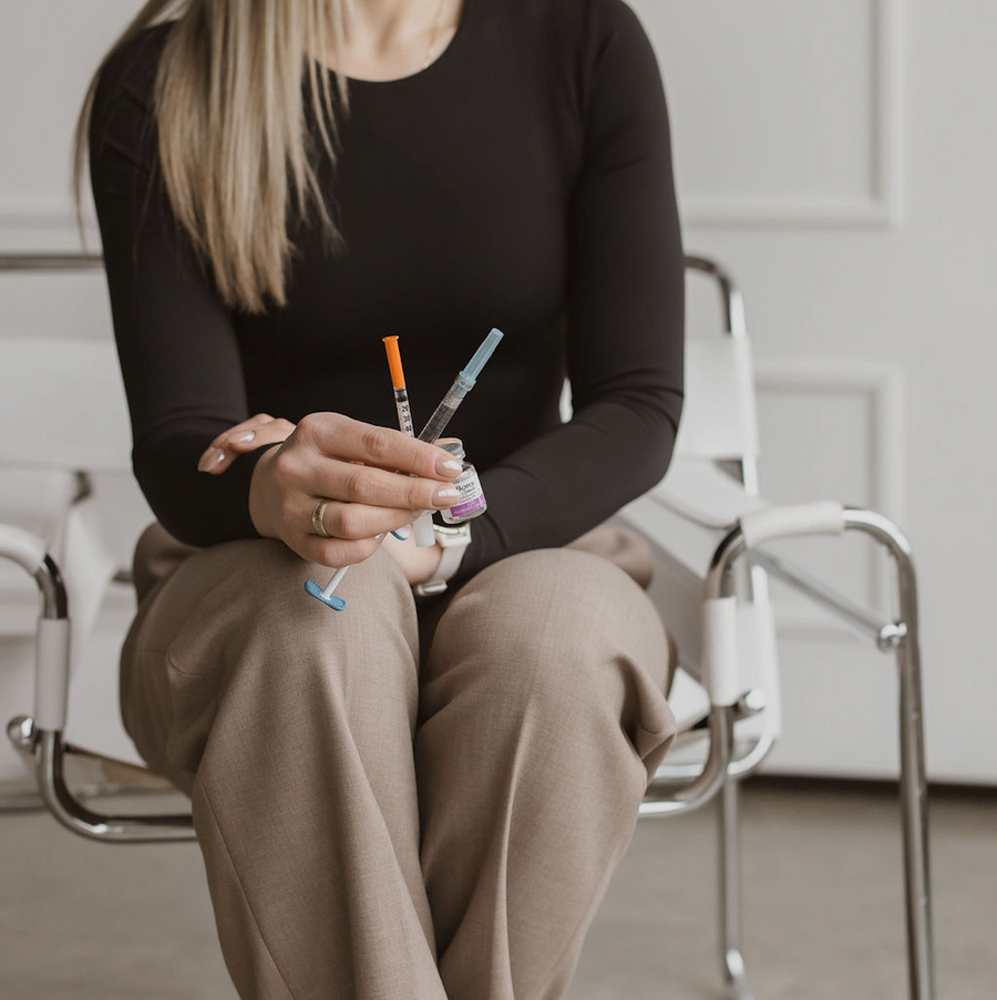woman holding botox vial and products